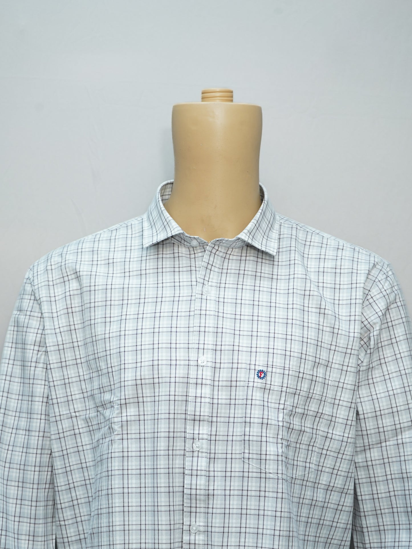 Close-up of a classic slate grid men's shirt, highlighting its white base and grey grid design.