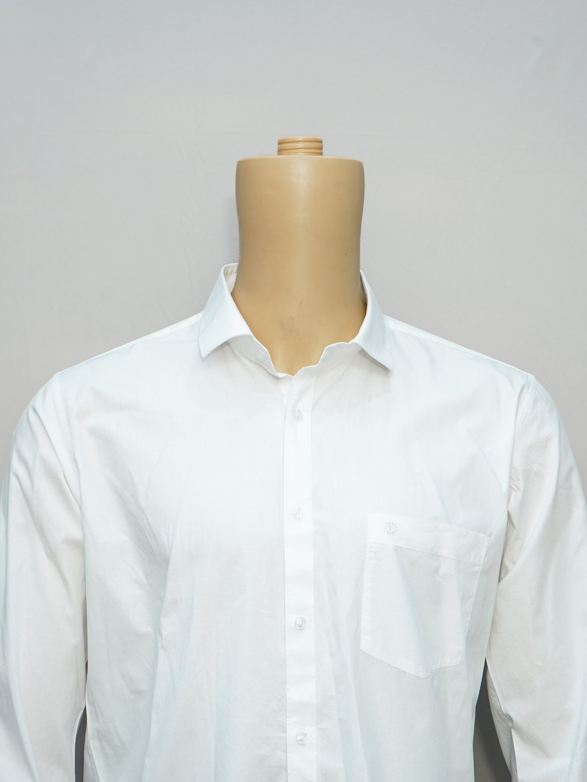 Close-up of a crisp white formal men's shirt, highlighting its tailored fit and classic collar details.