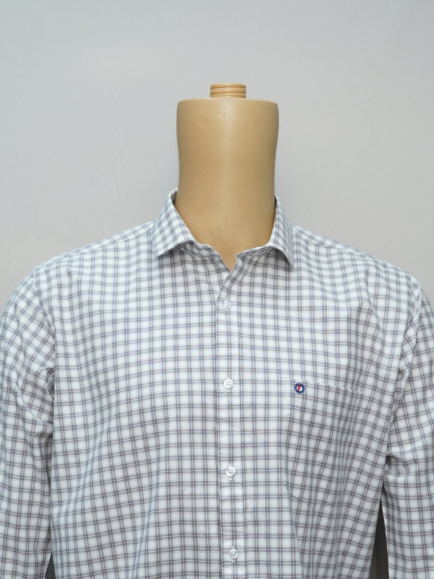 Close-up of a grey-white grid check men's shirt, showcasing its elegant checkered pattern and premium fabric.