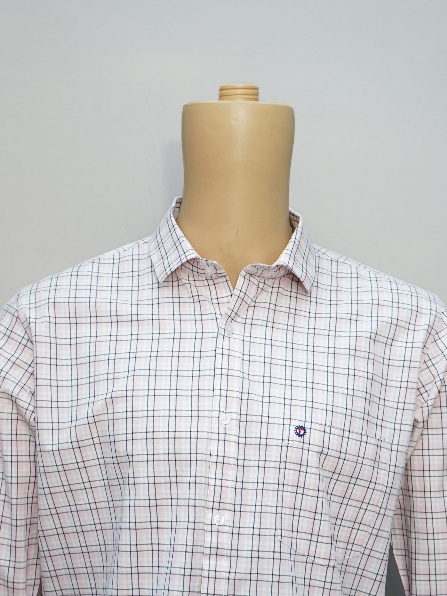 Close-up of a pink-white grid check men's shirt, showcasing its intricate grid pattern and elegant design.