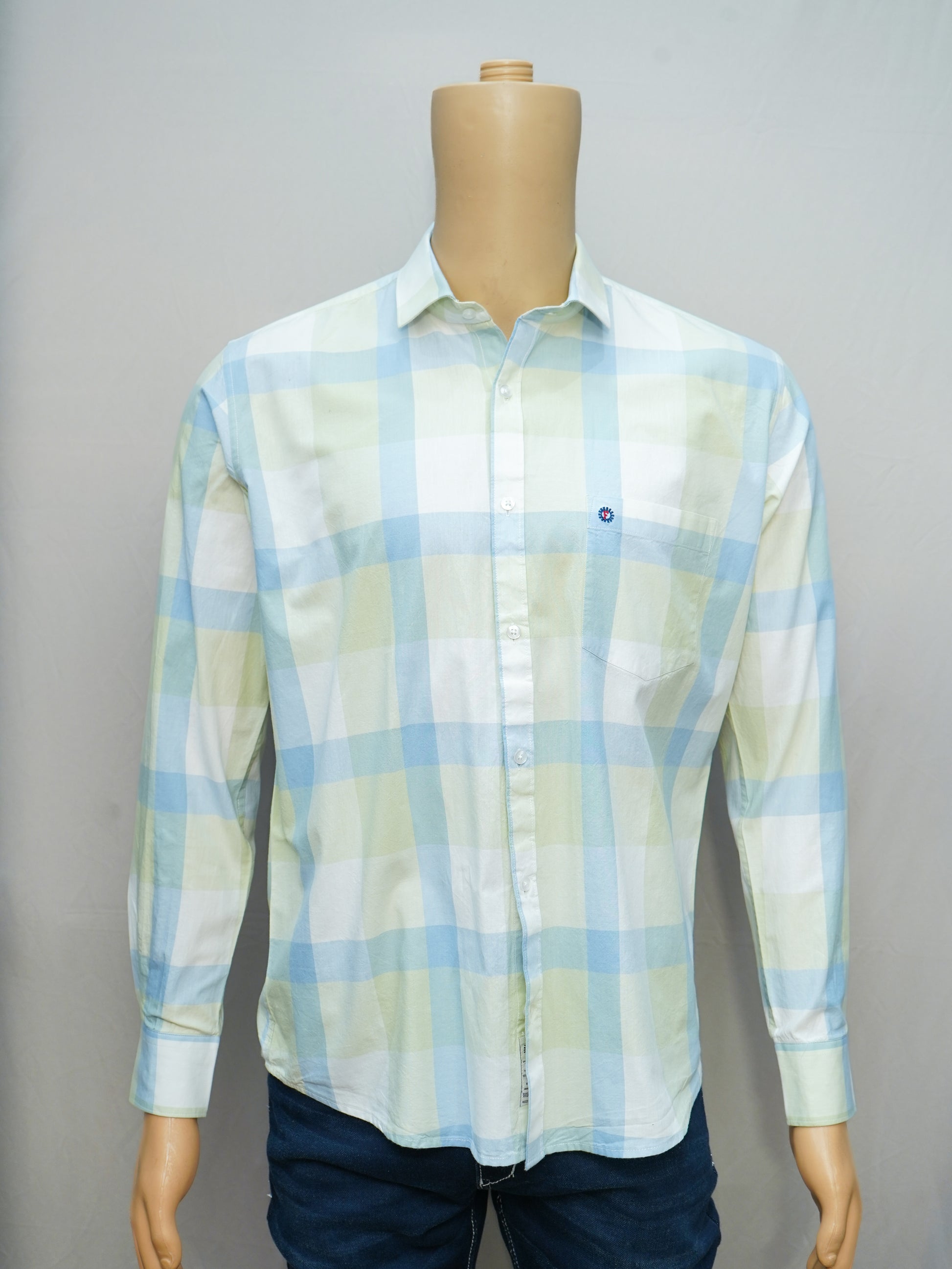 Front view of pastel green and blue check shirt styled on a mannequin.