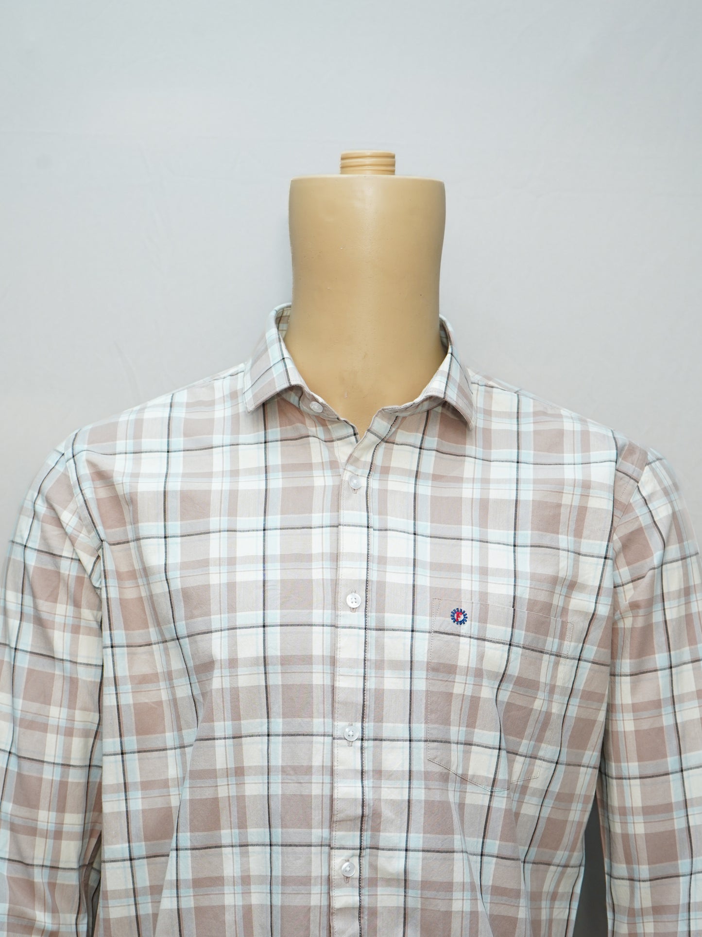 Close-up of the beige check shirt highlighting its premium cotton fabric and classic design.