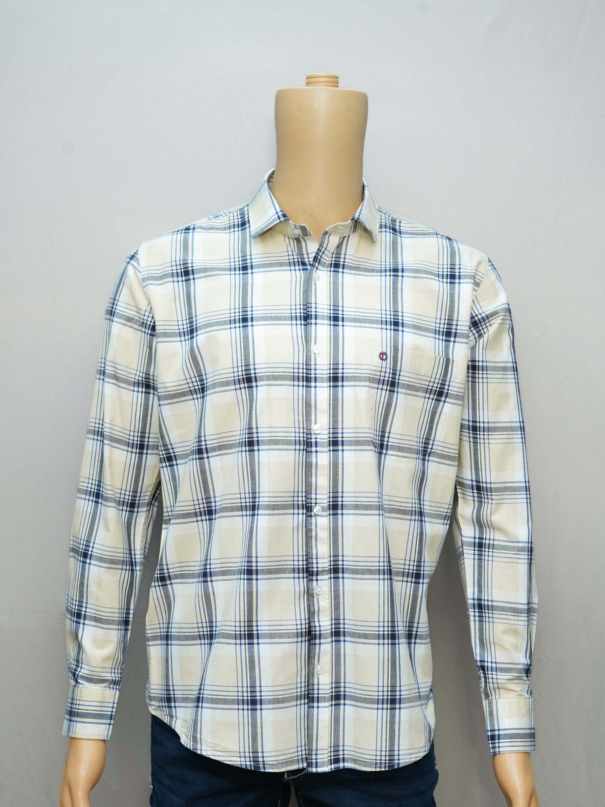 Full view of a beige and blue check men's shirt styled on a mannequin, showcasing its button-down design.