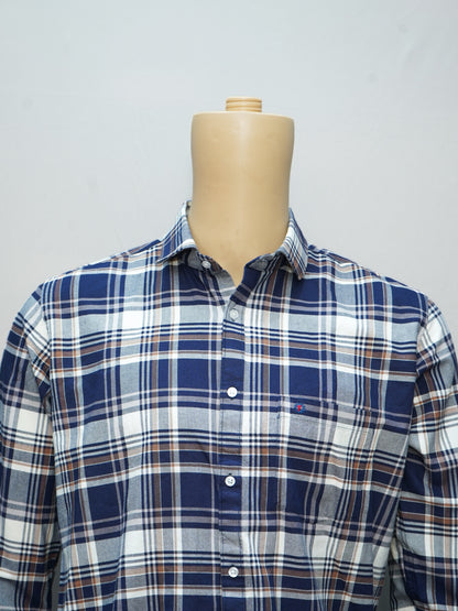 Close-up of navy blue and white check shirt highlighting the premium cotton fabric and button details