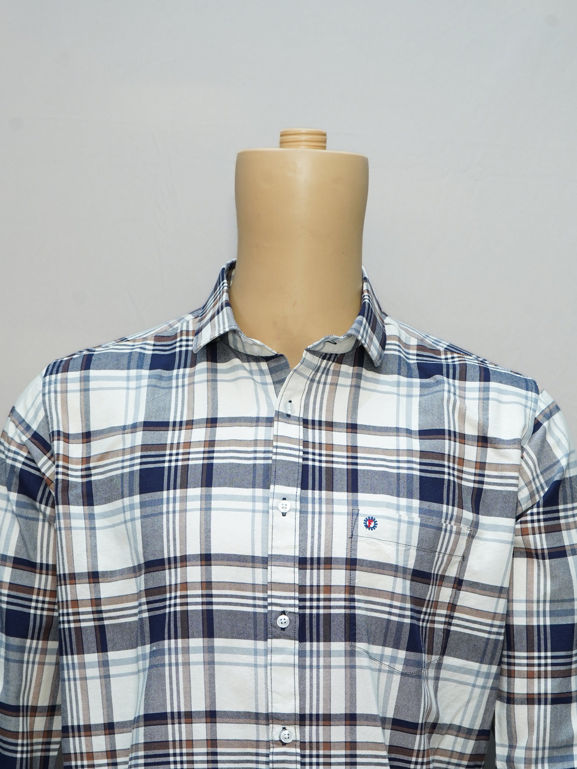 Close-up view of a classic blue and brown check shirt for men with a button-down collar, displayed on a mannequin.