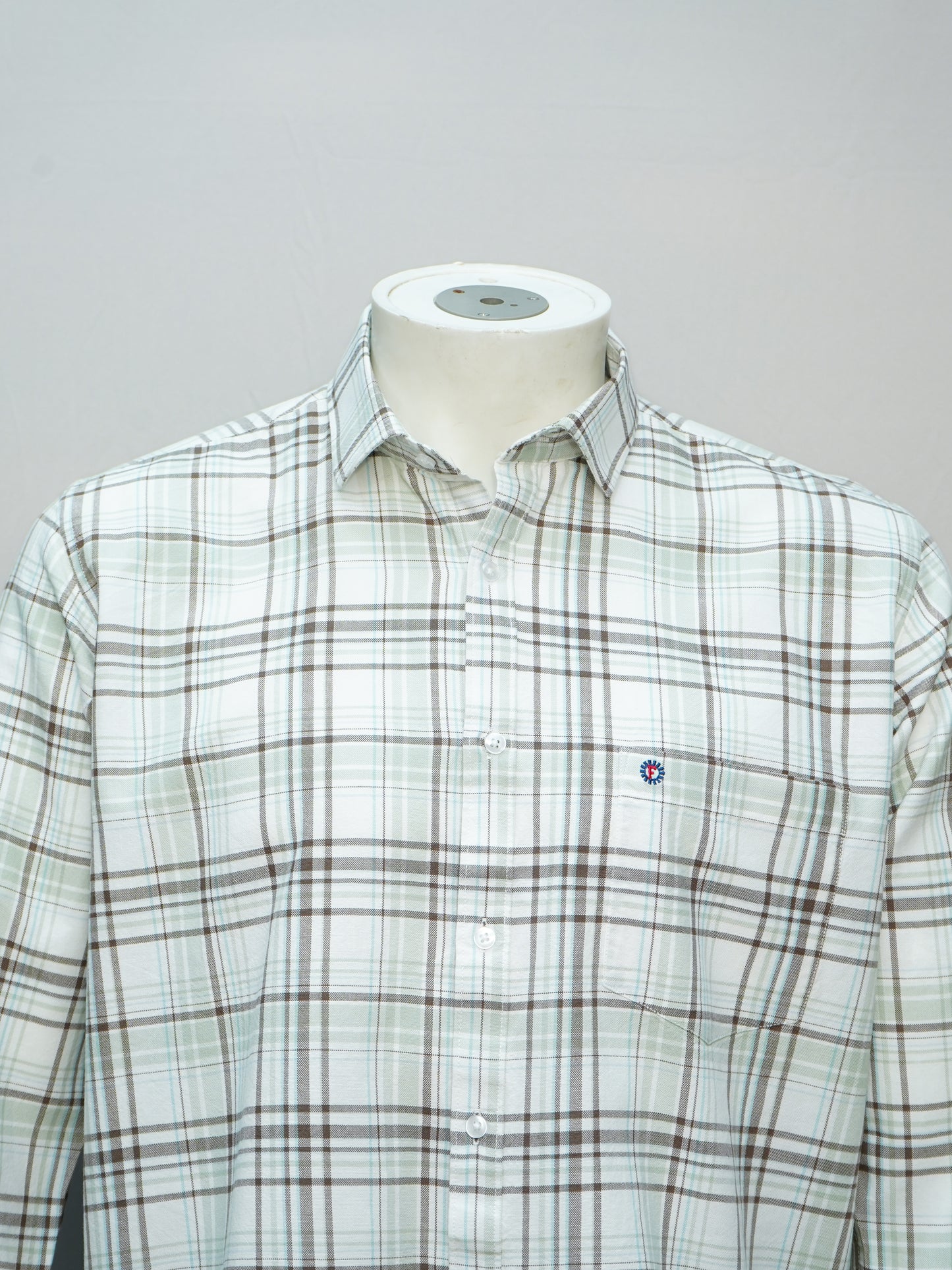 Front view of white and olive green check shirt for men.