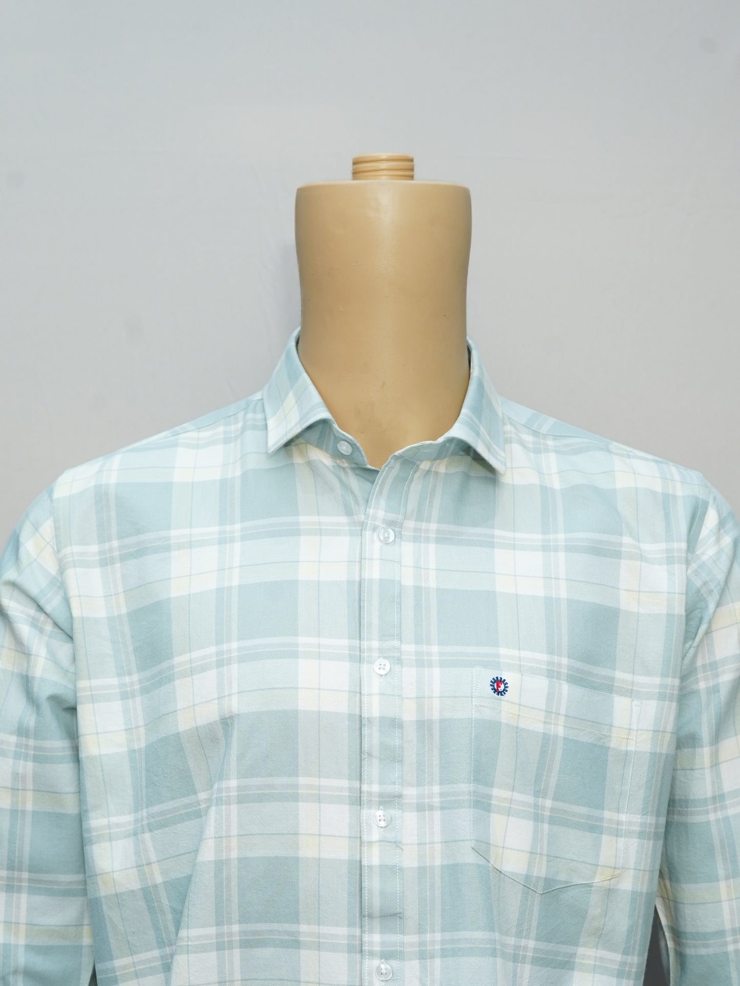 Close-up of a mint green check shirt showcasing premium fabric and pattern.