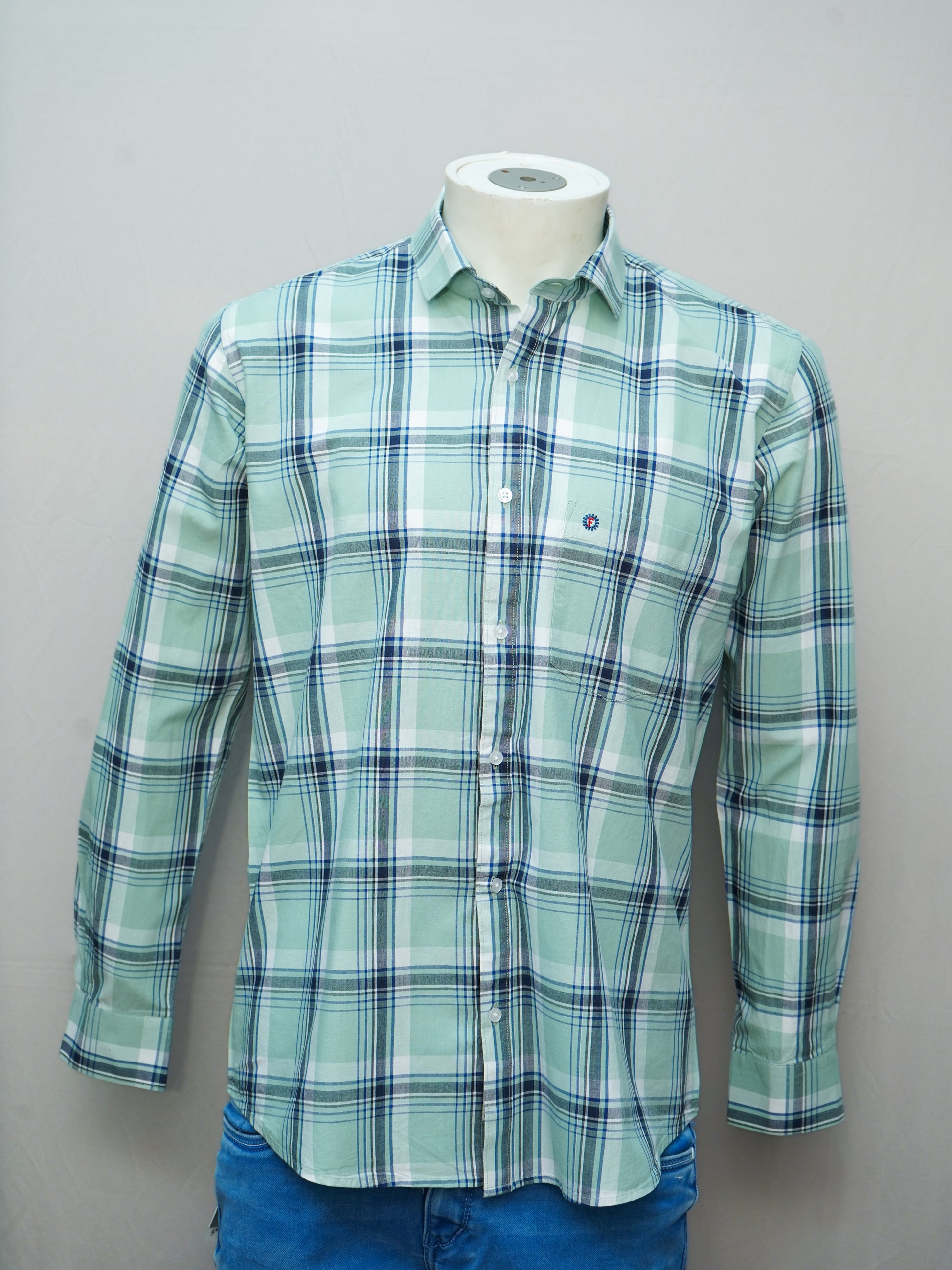 Full view of a mint green check men's shirt styled on a mannequin with a button-down design.